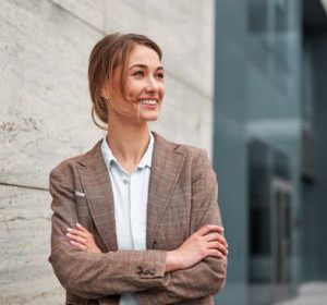 Businesswoman successful woman business person standing arms crossed outdoor corporate building exterior Smile happy caucasian confidence professional business woman middle age female entrepreneur